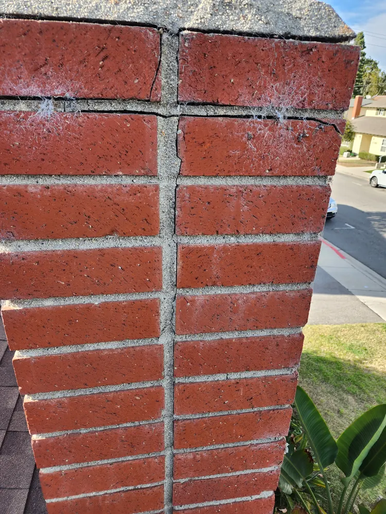 Close view of repaired mortar joints on a residential brick chimney